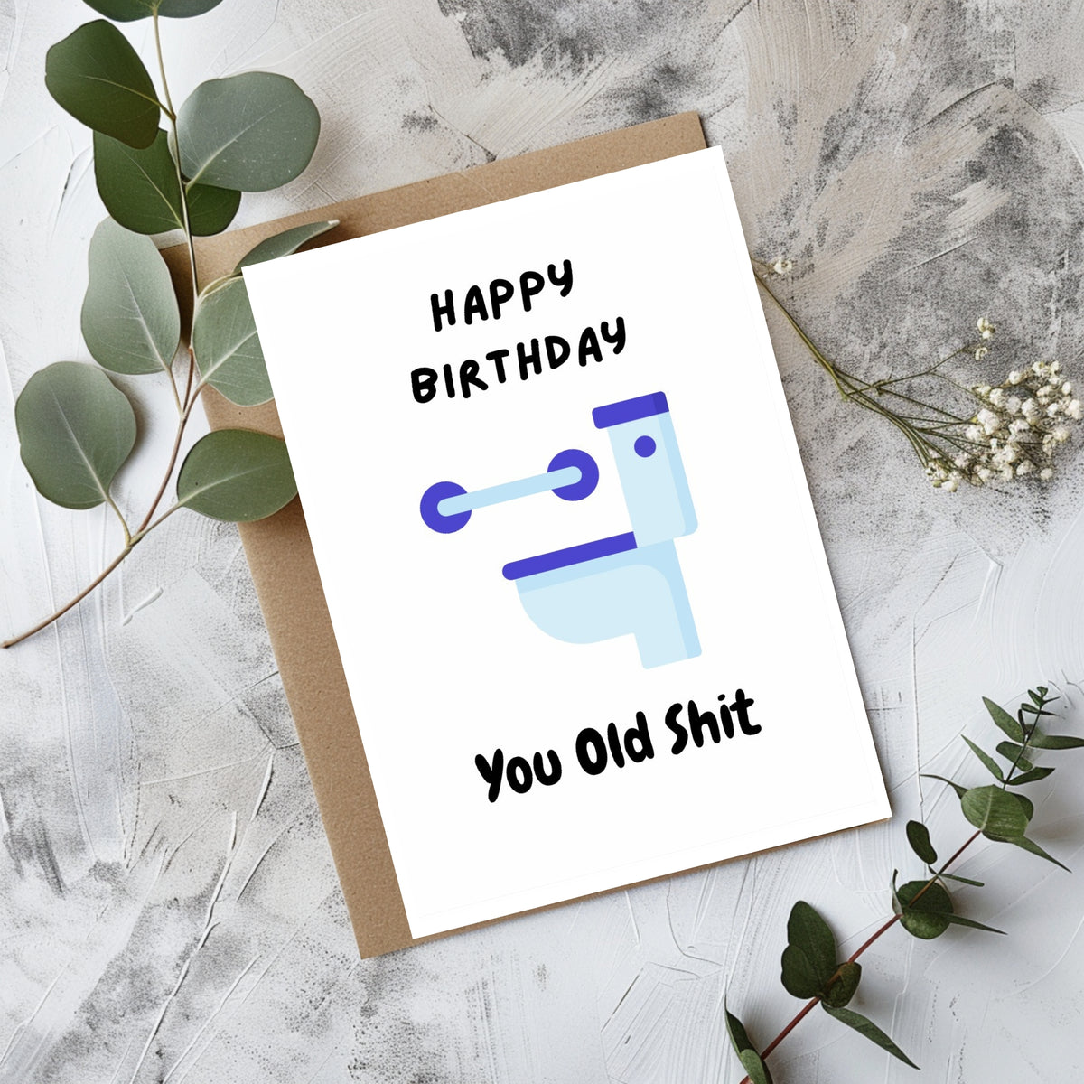 White rectangular birthday card with a light blue and purple toilet illustration, reading “Happy Birthday You Old Shit.”