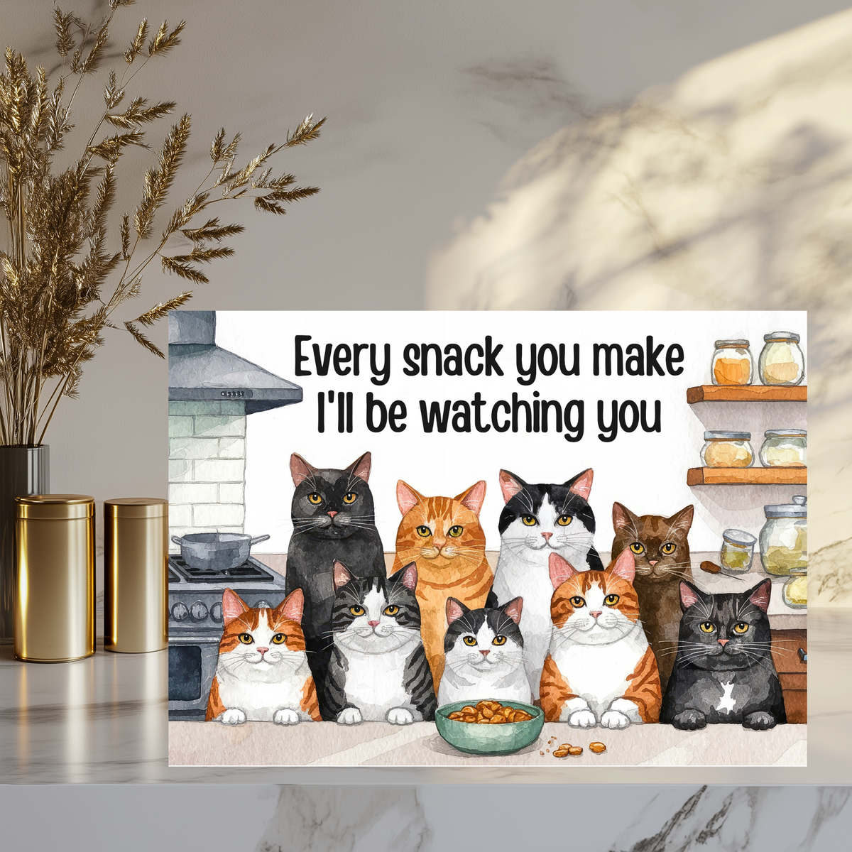 Aluminum sign with nine illustrated cats gathered around a snack bowl in a kitchen, reading “Every snack you make, I’ll be watching you.”