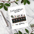 White rectangular wedding card with an illustrated bar, bottles and pink stools, reading “I can’t wait till your open bar” and “oops, Wedding.”