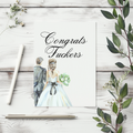 A wedding congratulations card featuring a watercolor illustration of a bride and groom with the text 'Congrats Fuckers' in black script, styled on a white wood background with greenery and stationery.