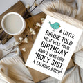 White rectangular card with a teal cartoon bird, reading “A little birdie told me it was your birthday and I was like ‘Holy shit, a talking bird!’”