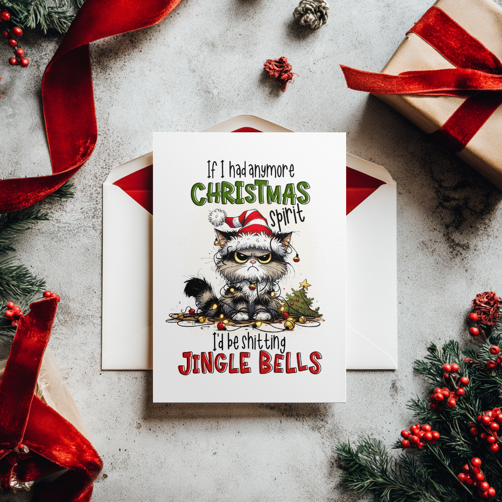 A Christmas greeting card featuring a cartoon raccoon in a Santa hat with the text 'If I had any more CHRISTMAS spirit I'd be shitting JINGLE BELLS', styled on a light gray surface with an envelope, wrapped gift, red ribbon, pine branches, and red berries.