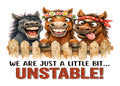 White aluminum sign with three grinning cartoon horses leaning over a wooden fence, reading “We are just a little bit… unstable!”